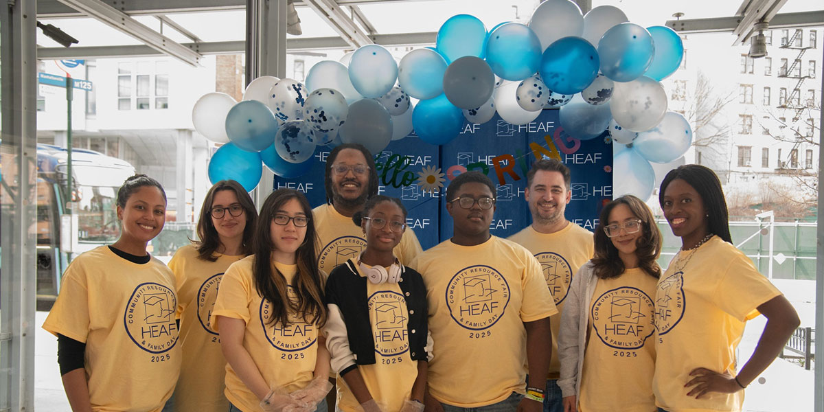 A group shot of HEAF students and instructors wearing yellow HEAF t-shirts